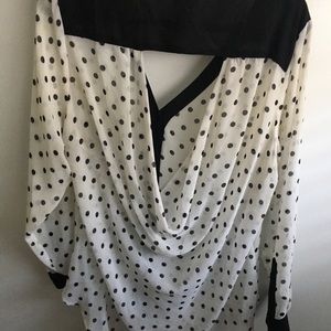 Polka dot shirt with a back cut out.